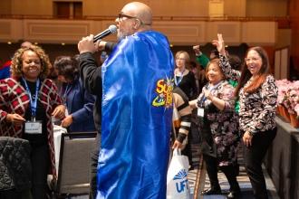 A paraprofessional performs for fellow attendees at the 2024 UFT Paraprofessional Festival and Awards Luncheon. 