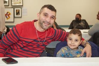 Guest Mohammed Rahman and his son enjoy themselves at the UFT Muslim Educators Committee 2024 Iftar Dinner.