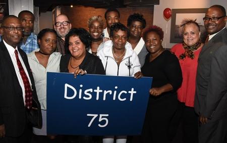 Paraprofessionals at PS 373 in Williamsburg are joined by Reginald Colvin (front,