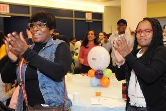 Teachers Katrina Thomas (left) and Lisa Highland of PS 289 in Brooklyn applaud d