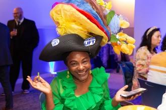 Guest and honoree Sonia Burke smiles for the camera showing off her homemade hat at the 2024 UFT Academic High School Awards. 