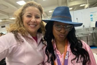 Two teachers take a selfie showing off their pink attire to support breast cancer awareness. 