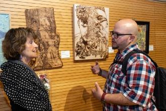 Joan Davidson (left) and Wilfred Santiago have a discussion at the New York City Art Teachers Association/UFT’s Dreams Art Show on May 10, 2024. 