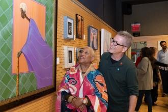 Mario Asaro, the president and executive chair of NYCATA, admires the work of Clarice Mims at New York City Art Teachers Association/UFT’s Dreams Art Show on May 10,  2024. Clarice is in front of Mario also looking at the art. 