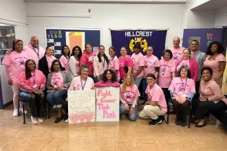 A group of staff at a public school in Queens wear matching pink attire in honor of a lost colleague. 