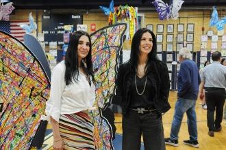 Two art teachers survey the gymnasium at IS 34's Art Show on Staten Island. 
