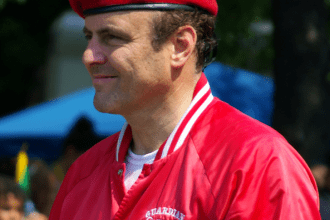 Side profile of a man with red beret