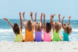 friends-on-beach-bright-swimsuits