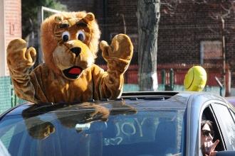  East Elmhurst Community School mascot Lucy the Lion (teacher Caitlin Antompietri) greets students along the parade route